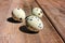 Close-up of quail eggs on wooden background. Natural hard light.