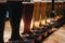 Close up of a rack of different kinds of beers, dark to light, on a table.