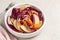 Close-up of radicchio, apple, walnut, carrot salad in a white bowl plate.