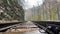 Close up of railway in mountainous terrain. Railway track in rainy weather in amazing and mysterious nature.