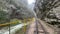 Close up of railway in mountainous terrain. Railway track in rainy weather in amazing and mysterious nature.