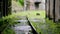 Close up of the railway track after the rain. The rain drops into a small puddle.