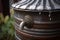 close-up of rain barrel with water cascading down its metal spout