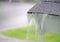 Close up on rain flowing from old roof