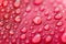 Close-up of raindrops on red surface