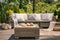 Close-up of a rattan outdoor table with coffee and croissants on