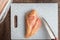 Close up of raw chicken breast on gray cutting board, chef knife