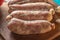 Close up of raw chorizos on a cuting board , typical Argentine sausages made with mixed pork and beef meat