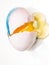 Close up of raw egg, colored and broken