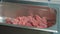Close-up of a raw meat cut in pieces for shashlik or shish kebab sprinkled wirh sea salt and other spices in metal tray.