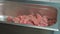 Close-up of a raw meat cut in pieces for shashlik or shish kebab sprinkled wirh sea salt and other spices in metal tray.