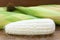 Close up raw white corn peeled can see inside on brown wood background