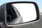 Close up on a rear external car rear mirror with clipping path