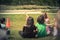 Close-up rear view multicultural children on grass meadow of outdoor game