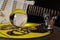 Close up of record player with yellow punk vinyl LP and crystal sphere glass ball und blurred electric guitar with black
