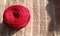 Close up red ball of knitting thread yarn on the carpet