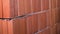 Close-up of red brick wall. Stock footage. Red brick wall of ceramic blocks was taken recently. New fresh wall built of