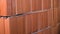 Close-up of red brick wall. Stock footage. Red brick wall of ceramic blocks was taken recently. New fresh wall built of