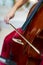 Close-up of red cello strings touched by a bow