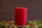 Close up red christmas candle on anthracite background christmas card