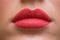 Close-up of red coral lips model, beautiful lipstick