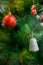 Close up of red dauble hanging from a decorated christmas tree