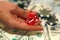 Close up of red dice in woman`s hand with cash and chips on blurred background