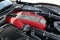 Close-up of a red Ferrari engine in a sleek, black car