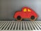 Close-up of red gingerbread car standing on the radiator like on