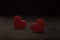 Close-up on a red glass hearts on a dark background. Valentine\\\'s concept. Symbol of love and Valentine\\\'s day.