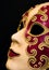 Close-up of red & gold carnival mask on black