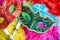 Close-up red and green carnival masquerade, venetian mask place on the colorful fluffy, Top view