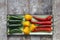 Close up of red, green and yellow hot peppers arranged on rectangular tray