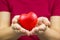 Close up a red heart shape in a hand of women The concept of a physical examination or heart health care