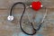 Close up red heart and stethoscope on wood table, world health d