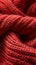 A close up of a red knitted fabric with some yarn, AI