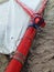 Close up of red mast and white cloth sail of traditional Caribbean boat on sand. Traditional nautical equipment, Gommier of the