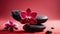 Close up of a red orchid with basalt stones on red colored background