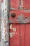 A close up of a red painted door with peeling paint, AI