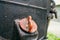 Close-up red plastic oil dipstick cap in the body of a dirty motoblock engine. Oil filler neck of the tractor. Oil smudges and