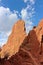 Close up of red rock pinnacles rising up against a blue sky with fluffy white clouds at the Garden of the Gods in Colorado