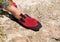 Close up of red rubber climbing shoe on rock