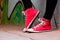 Close up of red sneakers worn by a teenager.