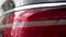 Close up of red tail lights, detail of modern, luxury, black SUV. Stock. Black car break lights, automotive lighting