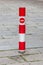 Close up red traffic pole and no entry sign with brick walk