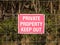 Close up of red and white country sign private property keep out