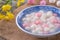 Close up of red and white tangyuan in blue bowl on wooden background for Winter solstice