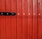 Close-up of red wood fence with white and black accents