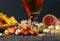 Close-up of refreshing alcoholic beverage. Dark ale in a glass. Composition of snacks. Beer and appetizers on a table