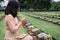 Close-Up of Religious Christian Woman Hands Clasped While Honoring and Praying to Military in War Cemetery. Teenager Woman in